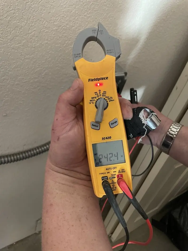 Voltage testing with clamp meter during Outlet Installation in Gainesville